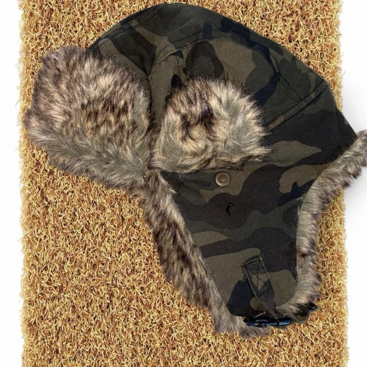Kids Black and green camo fur lined winter hat with adjustable chin strap